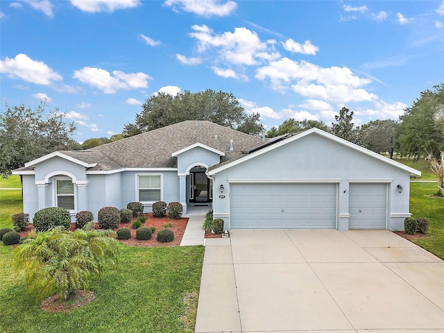 single story home featuring a front yard and a garage