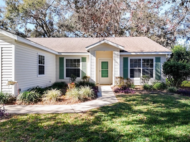 single story home featuring a front yard