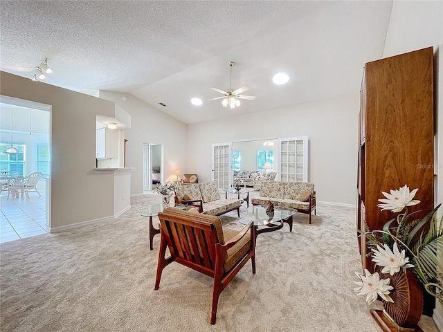 carpeted living room with french doors, a textured ceiling, ceiling fan, and lofted ceiling