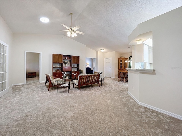 living room with carpet flooring, ceiling fan, a textured ceiling, and vaulted ceiling