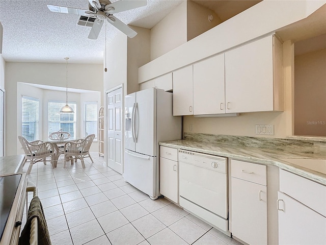 kitchen with pendant lighting, white appliances, white cabinets, ceiling fan, and a textured ceiling