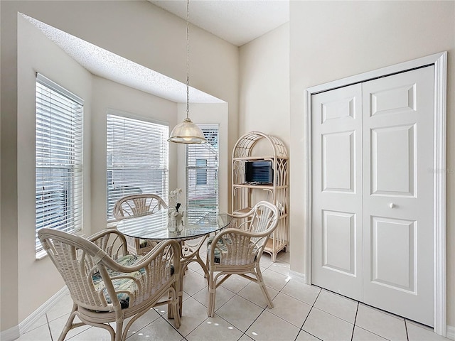 dining room with light tile patterned floors and a textured ceiling