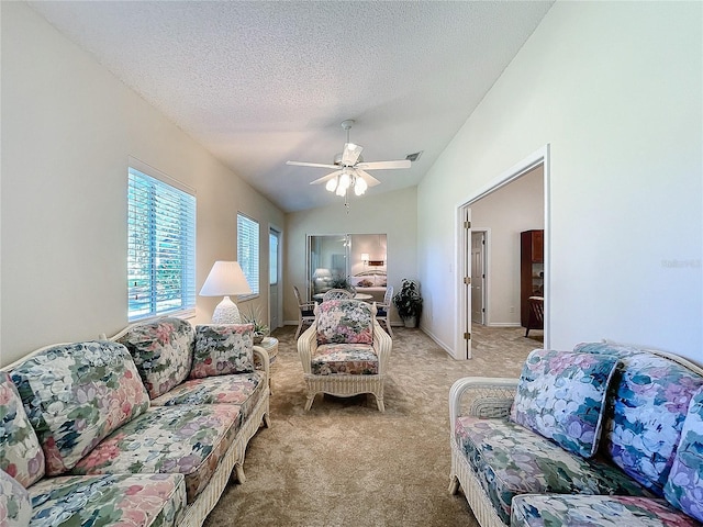 carpeted bedroom featuring ceiling fan and a textured ceiling