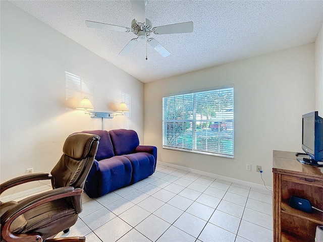 tiled office featuring a textured ceiling and ceiling fan