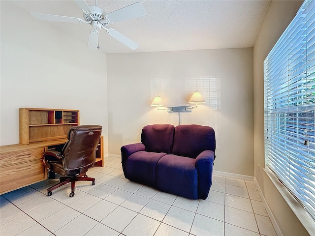 tiled office space featuring ceiling fan and a healthy amount of sunlight