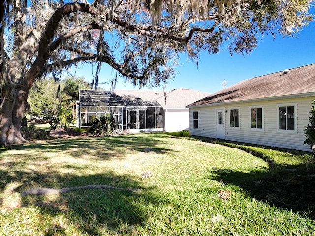 view of yard with glass enclosure