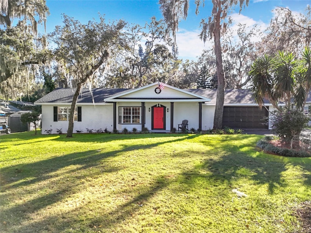 ranch-style home with a front yard and a garage