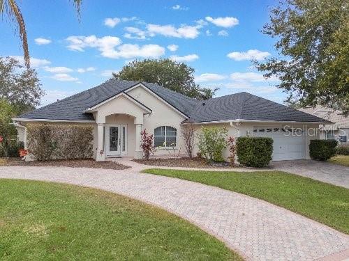 ranch-style house with a front yard and a garage