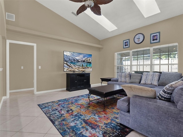 living room with high vaulted ceiling, ceiling fan, a skylight, and light tile patterned floors