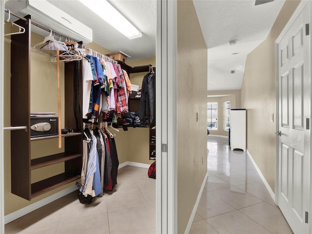 walk in closet with light tile patterned flooring