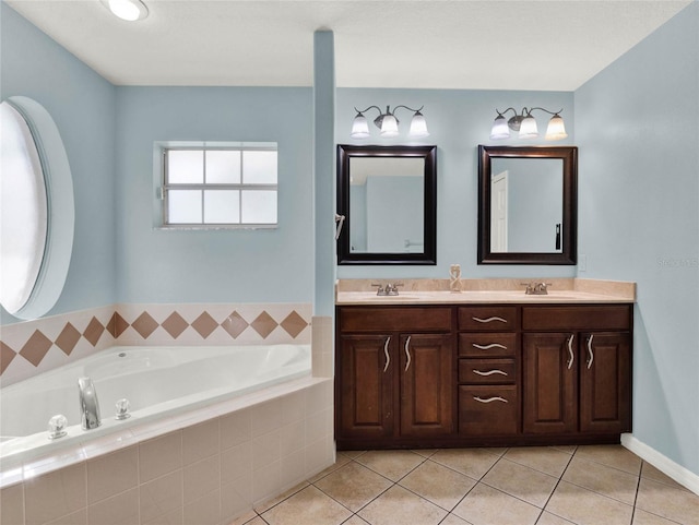 bathroom with tile patterned floors, tiled tub, and vanity