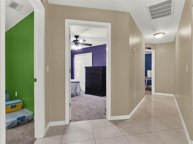 hallway featuring light tile patterned floors