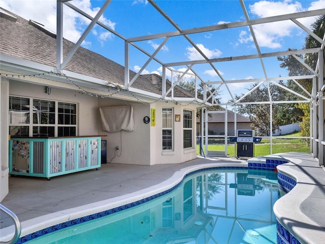 view of pool with a lanai, a grill, and a patio