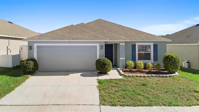 single story home featuring a garage and a front lawn