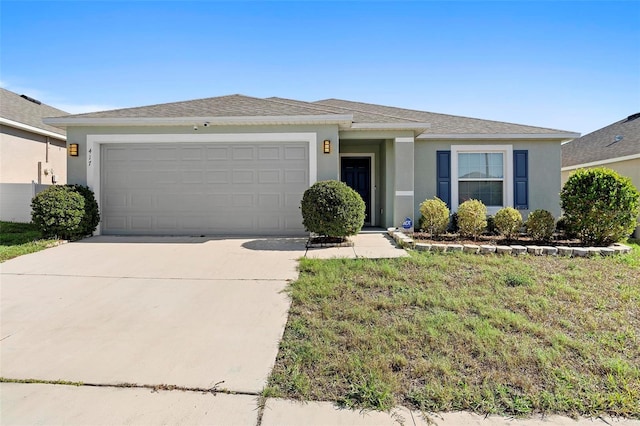 single story home featuring a garage and a front lawn