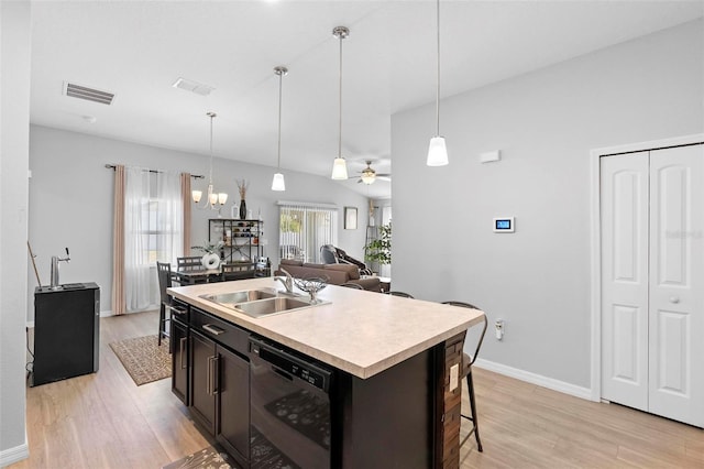 kitchen with sink, black dishwasher, decorative light fixtures, a center island with sink, and ceiling fan with notable chandelier