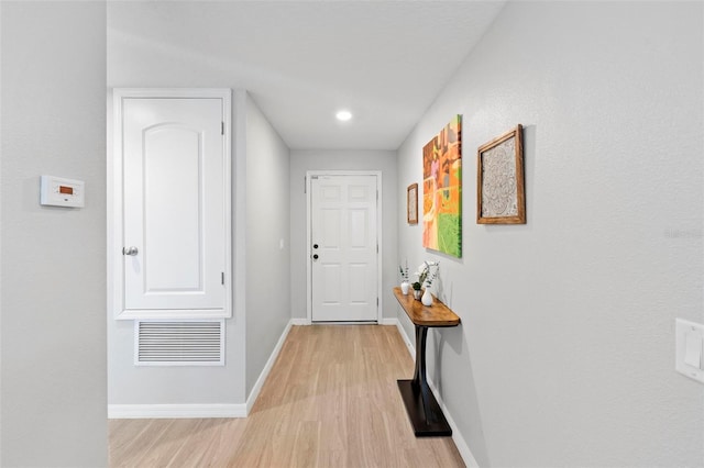 hall with light hardwood / wood-style floors