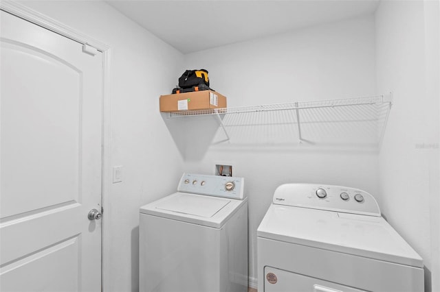 laundry room with washing machine and clothes dryer