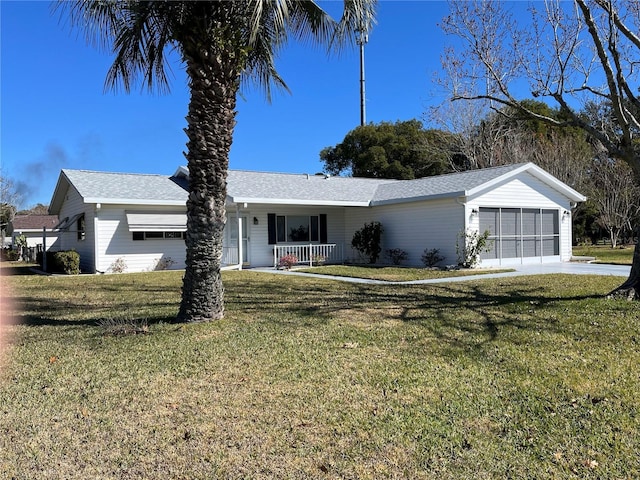 ranch-style home with covered porch, a garage, and a front lawn