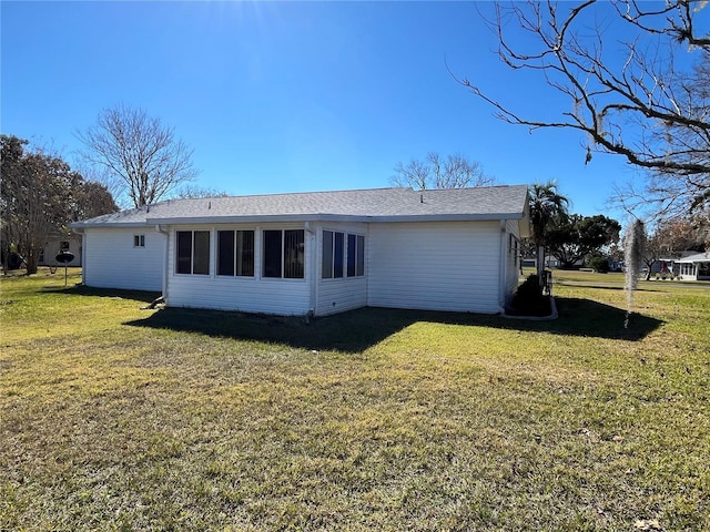 back of house with a lawn