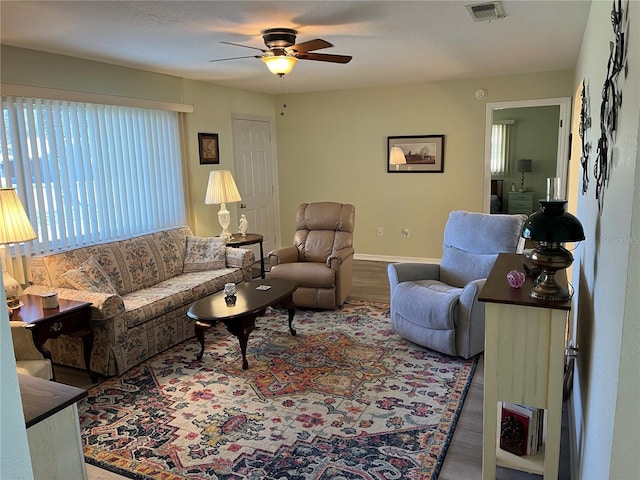 living room featuring hardwood / wood-style floors, ceiling fan, and plenty of natural light