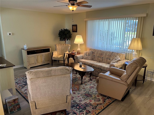 living room with ceiling fan and light wood-type flooring