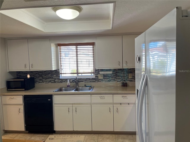 kitchen featuring a raised ceiling, sink, white fridge with ice dispenser, and black dishwasher