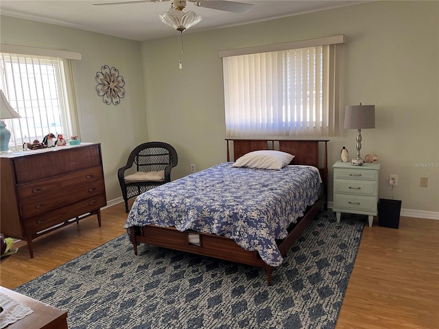 bedroom with ceiling fan and light hardwood / wood-style flooring