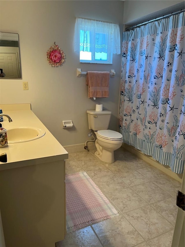 bathroom with tile patterned floors, vanity, curtained shower, and toilet