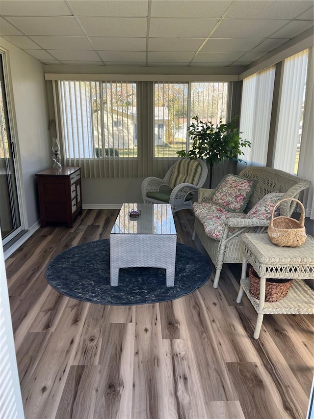 living room with a paneled ceiling and hardwood / wood-style flooring