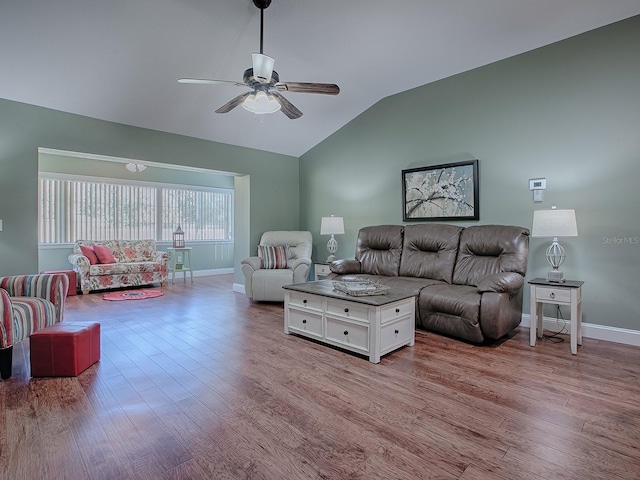 living room with light hardwood / wood-style floors, lofted ceiling, and ceiling fan