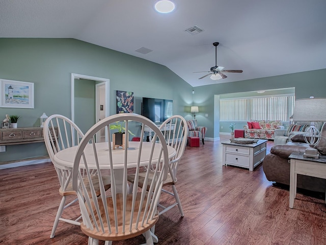 dining room featuring ceiling fan, lofted ceiling, and hardwood / wood-style flooring