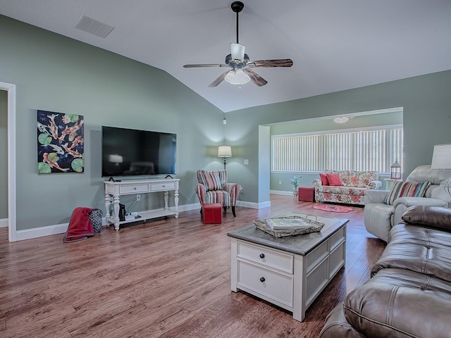 living room featuring ceiling fan, light hardwood / wood-style flooring, and lofted ceiling