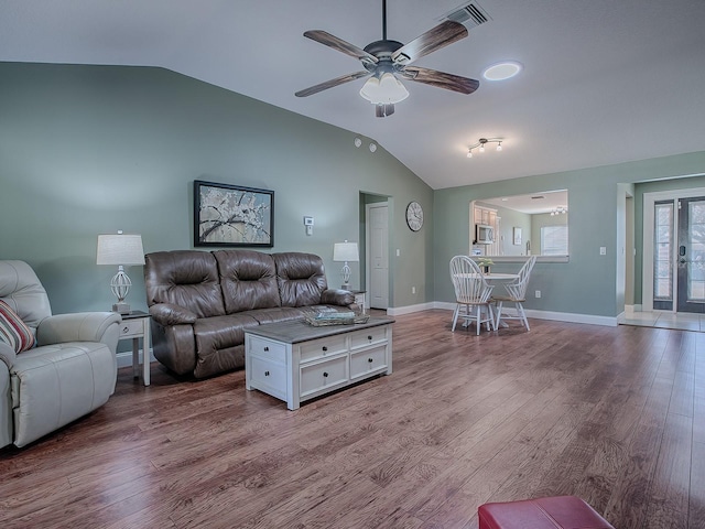 living room with vaulted ceiling, ceiling fan, and wood-type flooring