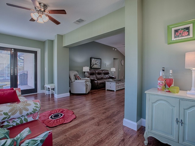 living room featuring ceiling fan, vaulted ceiling, dark hardwood / wood-style floors, and french doors