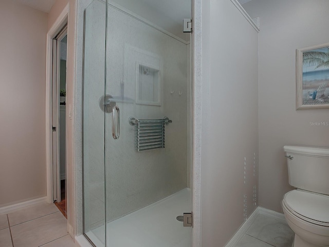 bathroom with toilet, tile patterned floors, and an enclosed shower