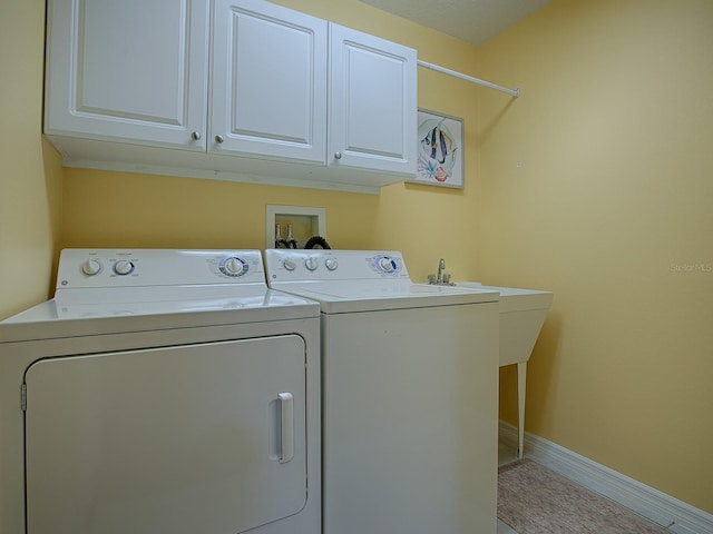 laundry area with cabinets and washer and dryer