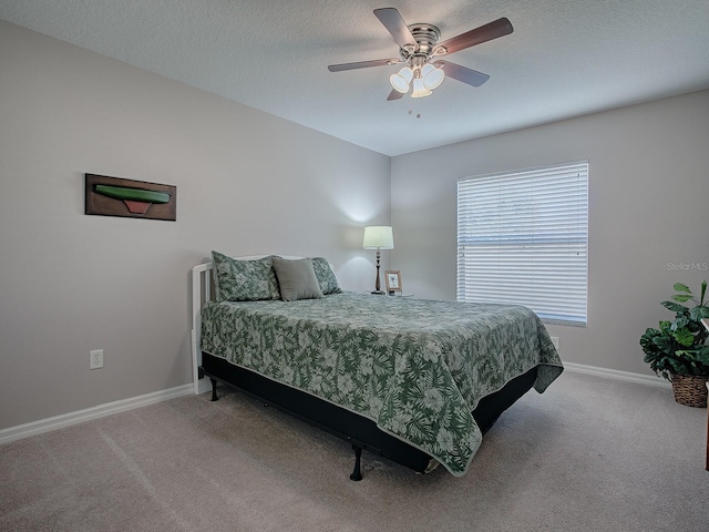 carpeted bedroom with a textured ceiling and ceiling fan