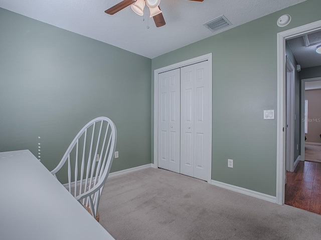 home office featuring light carpet and ceiling fan