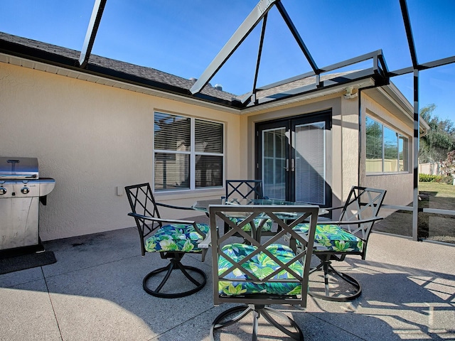 view of patio / terrace with a lanai and grilling area