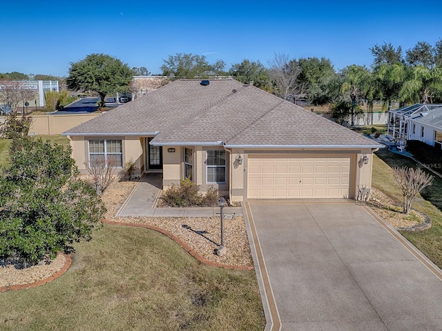 single story home featuring a garage and a front yard