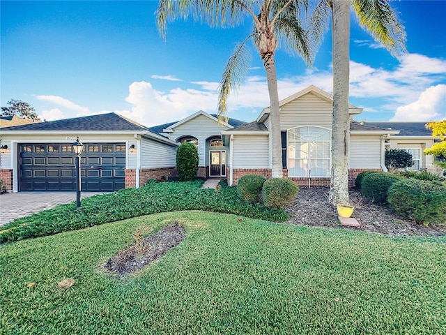 single story home with a garage and a front lawn