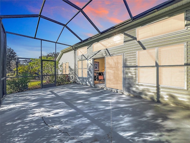 patio terrace at dusk featuring a lanai