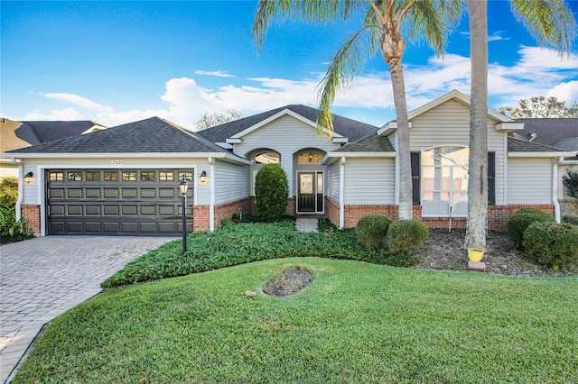 ranch-style house featuring a front lawn and a garage