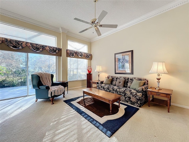 carpeted living room with a textured ceiling, ceiling fan, and ornamental molding