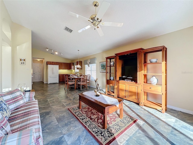 living room featuring vaulted ceiling and ceiling fan