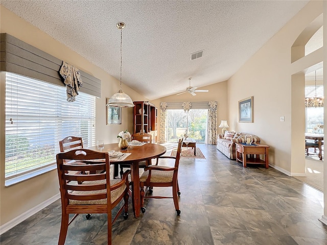 dining room with a textured ceiling, ceiling fan, and lofted ceiling