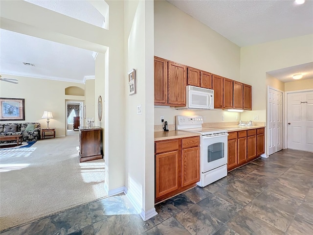 kitchen featuring ceiling fan, dark carpet, white appliances, and high vaulted ceiling