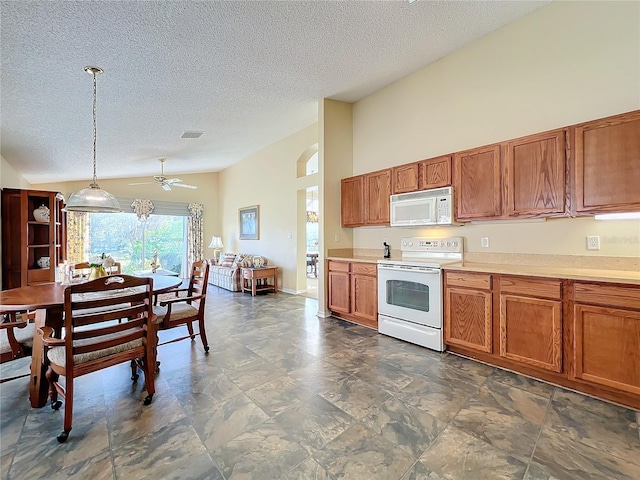 kitchen featuring ceiling fan, high vaulted ceiling, pendant lighting, a textured ceiling, and white appliances