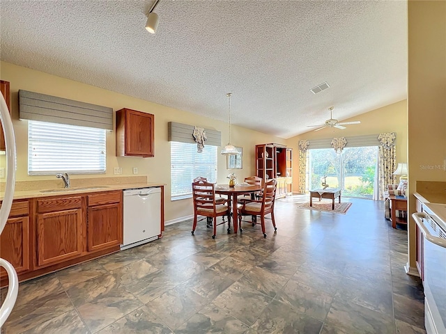 kitchen featuring pendant lighting, dishwasher, lofted ceiling, sink, and ceiling fan